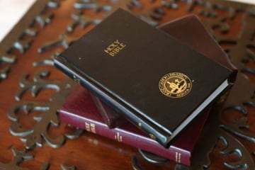 The Bible laying on an ornate tablecloth