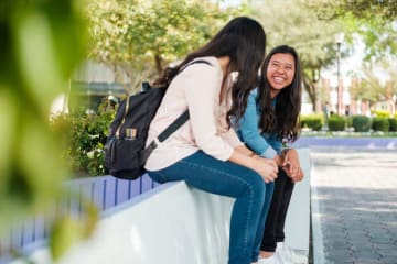 two girls talking with each other at school