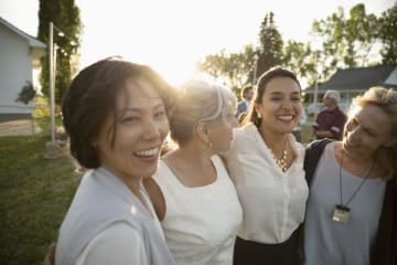 four women laughing together