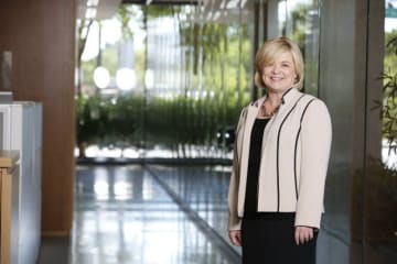 Adult woman stands in classroom