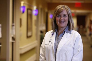 Female DNP wearing white coat in hospital