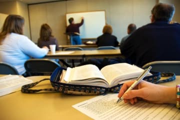 Students in the classroom writing an assignment