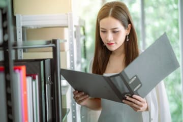 Woman looking through a binder