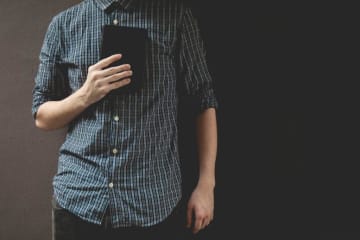 man holding a book on his chest