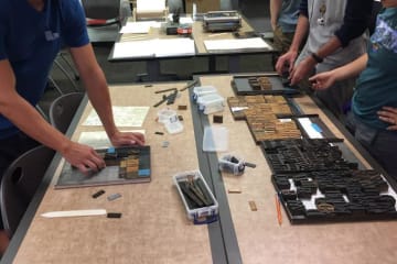 Students typesetting with wood type