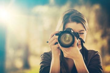 girl holding camera and taking pictures