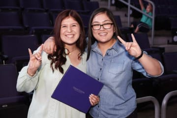 two students holding a lopes up