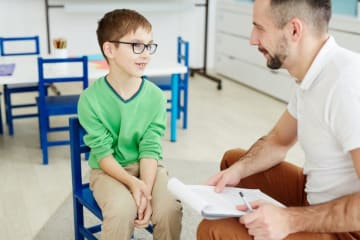 a special education teacher working with a student