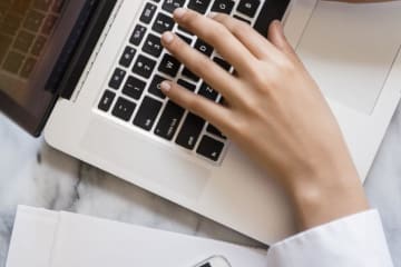 Woman typing on laptop