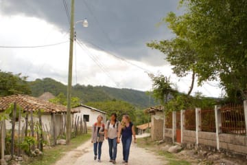 girls walking on dirt path