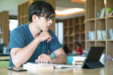 Male student working on laptop