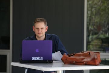 Doctoral learner working on a laptop