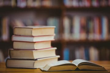 Stacked books in a library settting