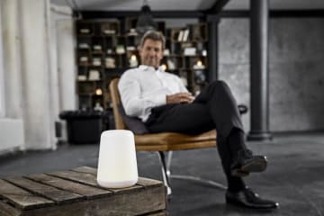 Man sitting beside a digital assistant