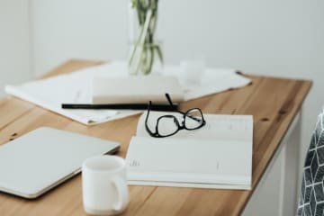 glasses resting on an open book