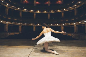 Ballerina taking a knee after a performance