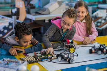Young children working with robots