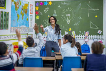 teacher smiling while teaching her students