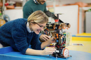 A woman working with a robot