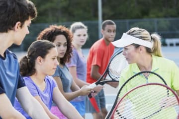 kids learning to play tennis