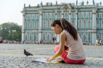 Young female tourist studying map