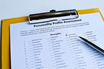 Personality profile assessment on a clipboard with an x next to one characteristic