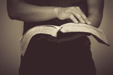 person holding bible