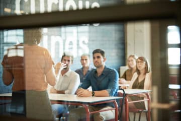 Professor teaching adults in airy classroom