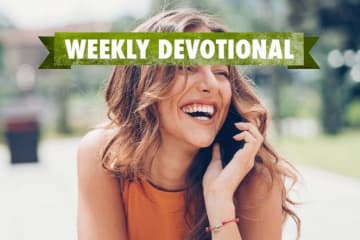 Weekly Devotional: Woman a cellphone smiling