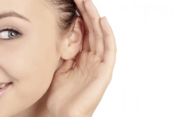 a girl cupping her ear