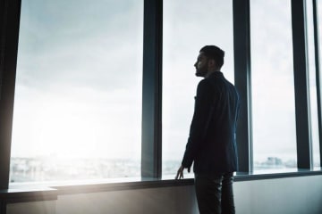 man thinking and looking out of window