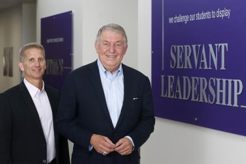 Dr. Gibb and Jerry Coangelo next to CCOB's Servant Leadership pillar