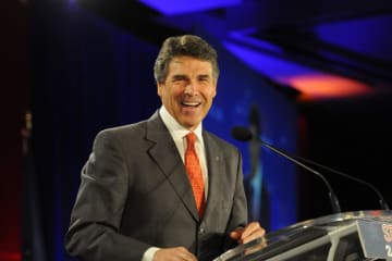 a man standing at a podium speaking