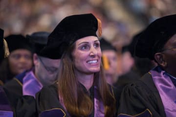 Doctoral graduates listen to commencement speeches