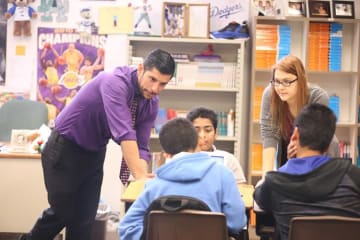 Teacher helping students in classroom