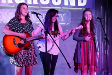 three girls playing instruments