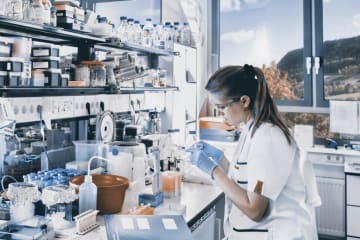 person working with chemicals in a lab