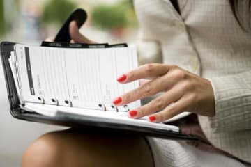 Woman flipping through agenda