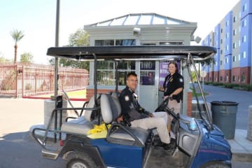 two public safety officers in a golf cart