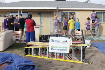 people working on building a house