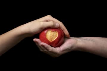 people holding an apple 