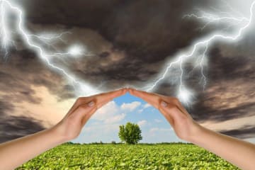 hands blocking a storm