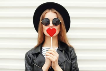 Girl with a heart-shaped lollipop