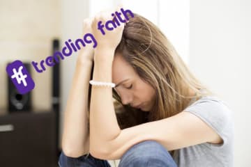 Student worrying under the Trending Faith logo