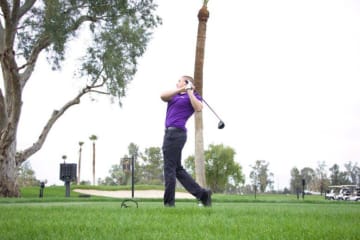 A student athlete playing golf