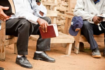 men having a bible study outside