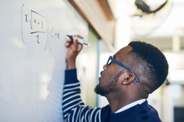 Man writing math on the board