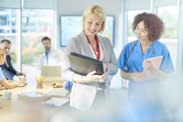 a nurse and administrator talking 