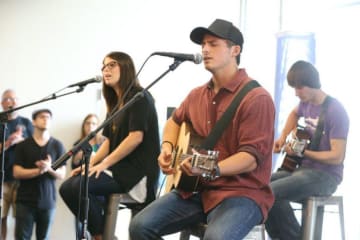 Three students playing music