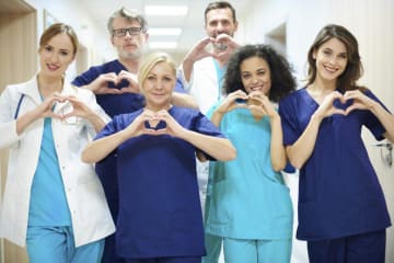 a group of nurses making heart signs